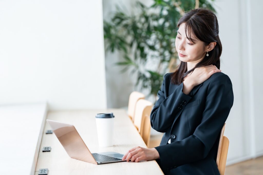 肩こり・腰痛に悩んでいる女性の様子
